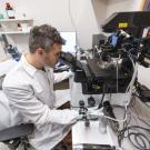 A look at a researcher looking through a microscope